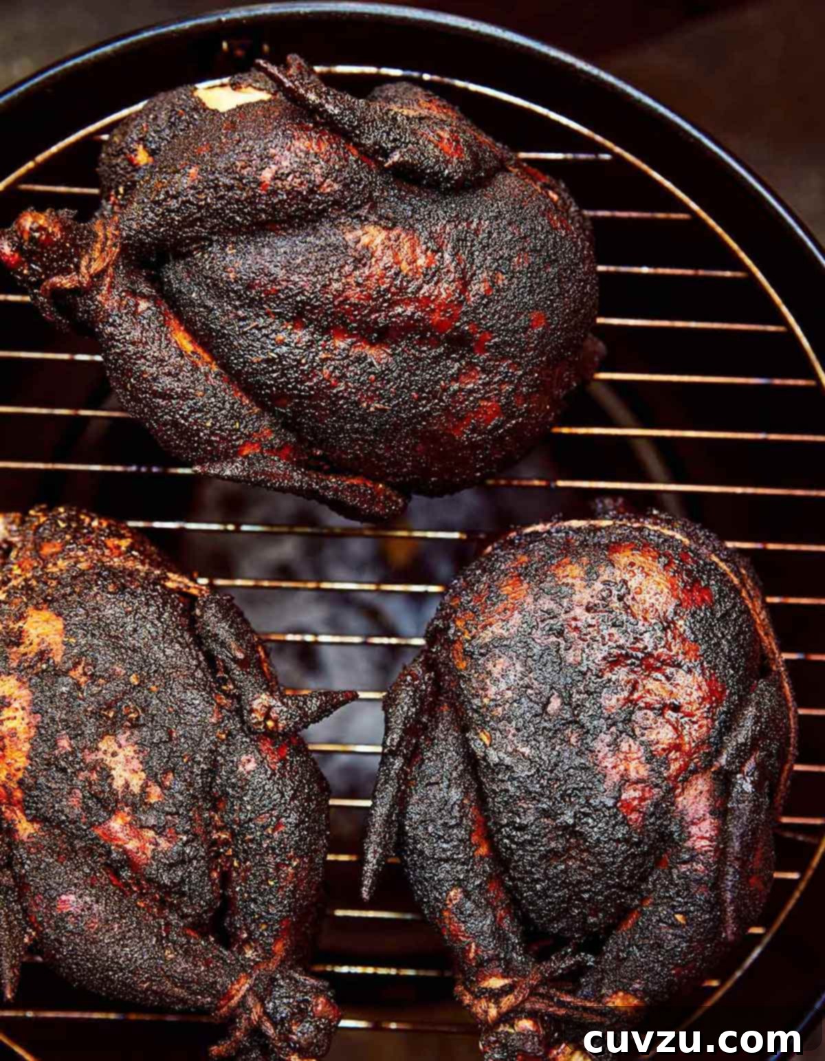 Smoky Chicken Perfection 5 Three whole smoked chickens on a round grill.