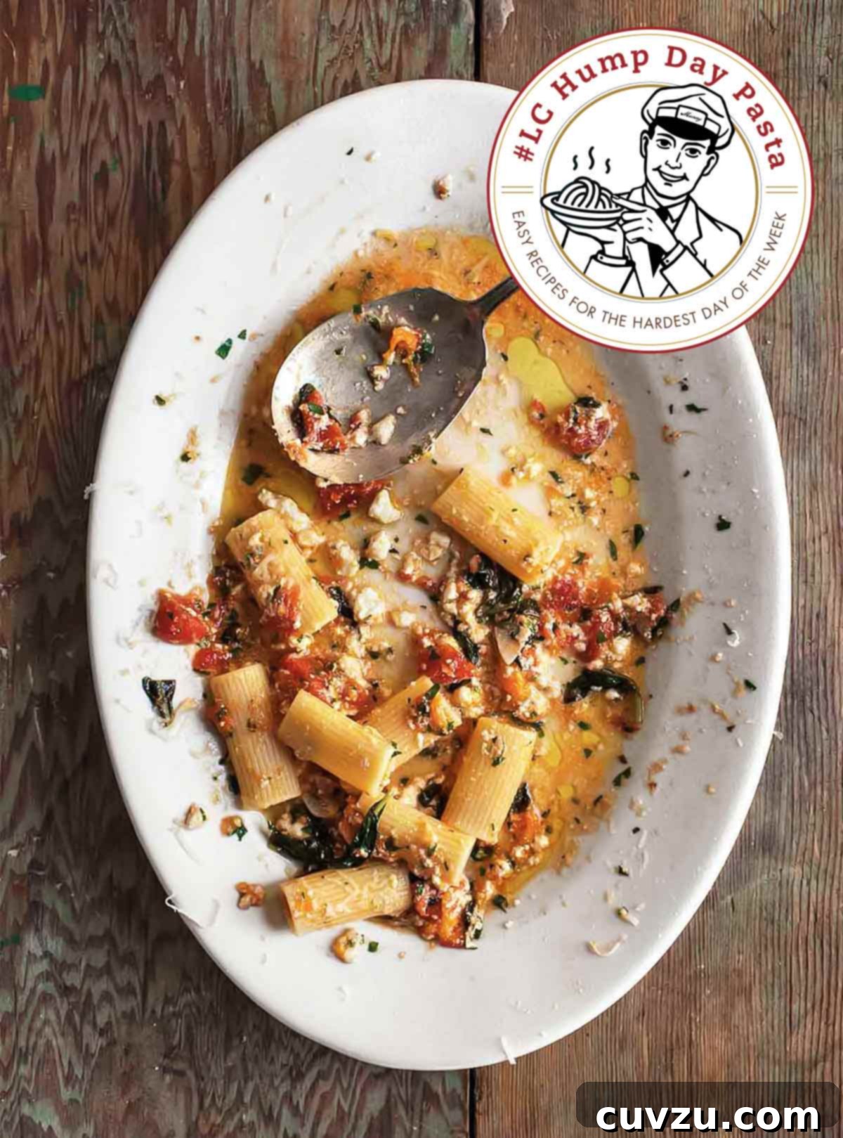 Sicily's Iconic Eggplant Pasta 2 Pasta alla Norma, a classic Sicilian dish featuring pasta, roasted eggplant, fresh tomatoes, ricotta salata, and fragrant herbs, served on a white oval plate with a spoon resting on the side.