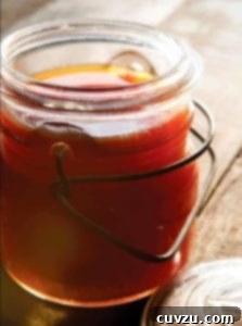 A glass jar filled with rich beef bone broth.