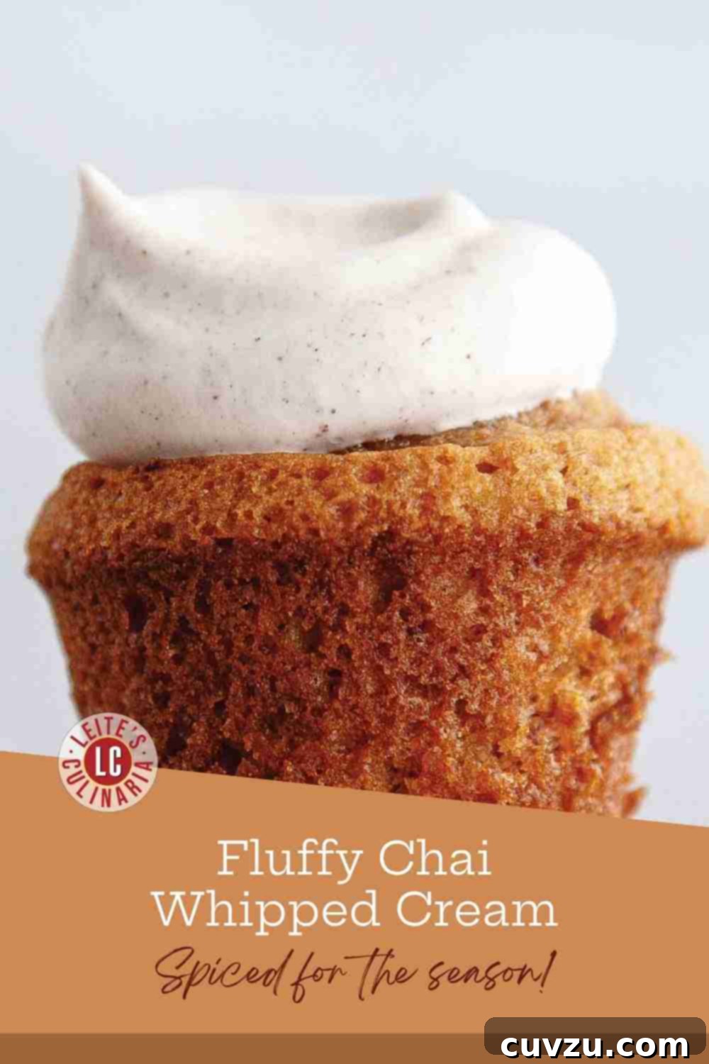 Warm Spiced Chai Whipped Cream 3 A large, fluffy dollop of chai-spiced whipped cream, elegantly dusted with cinnamon, sitting atop a moist muffin.