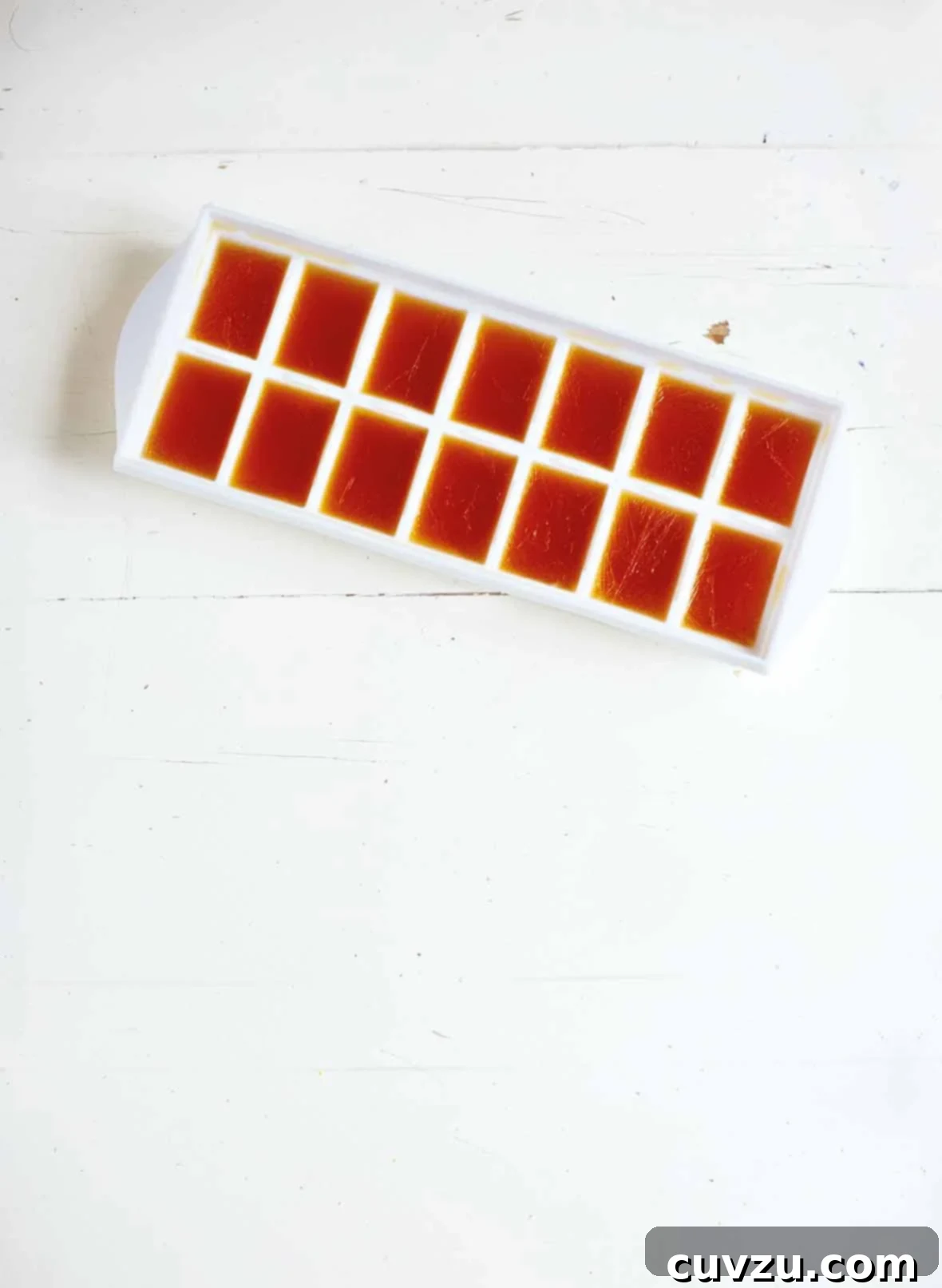 How to Freeze Stock 2 A white plastic ice cube tray filled with frozen stock cubes.