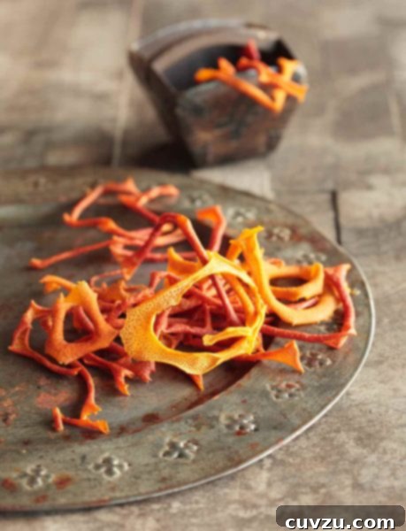 A pile of dried orange peel rings on a silver plate.