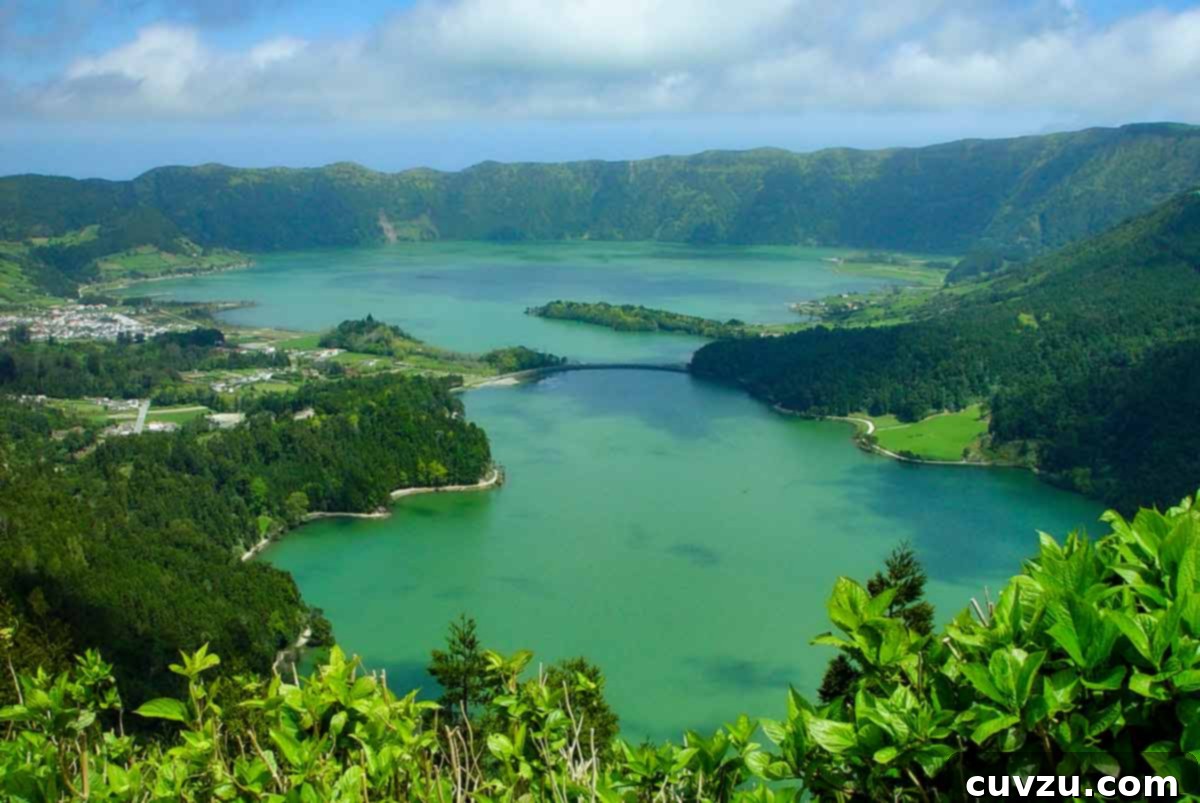 Azores The Atlantic's Hearty Plate 3 Gorgeous green and blue photo of Sete Cidades with clouds and trees.