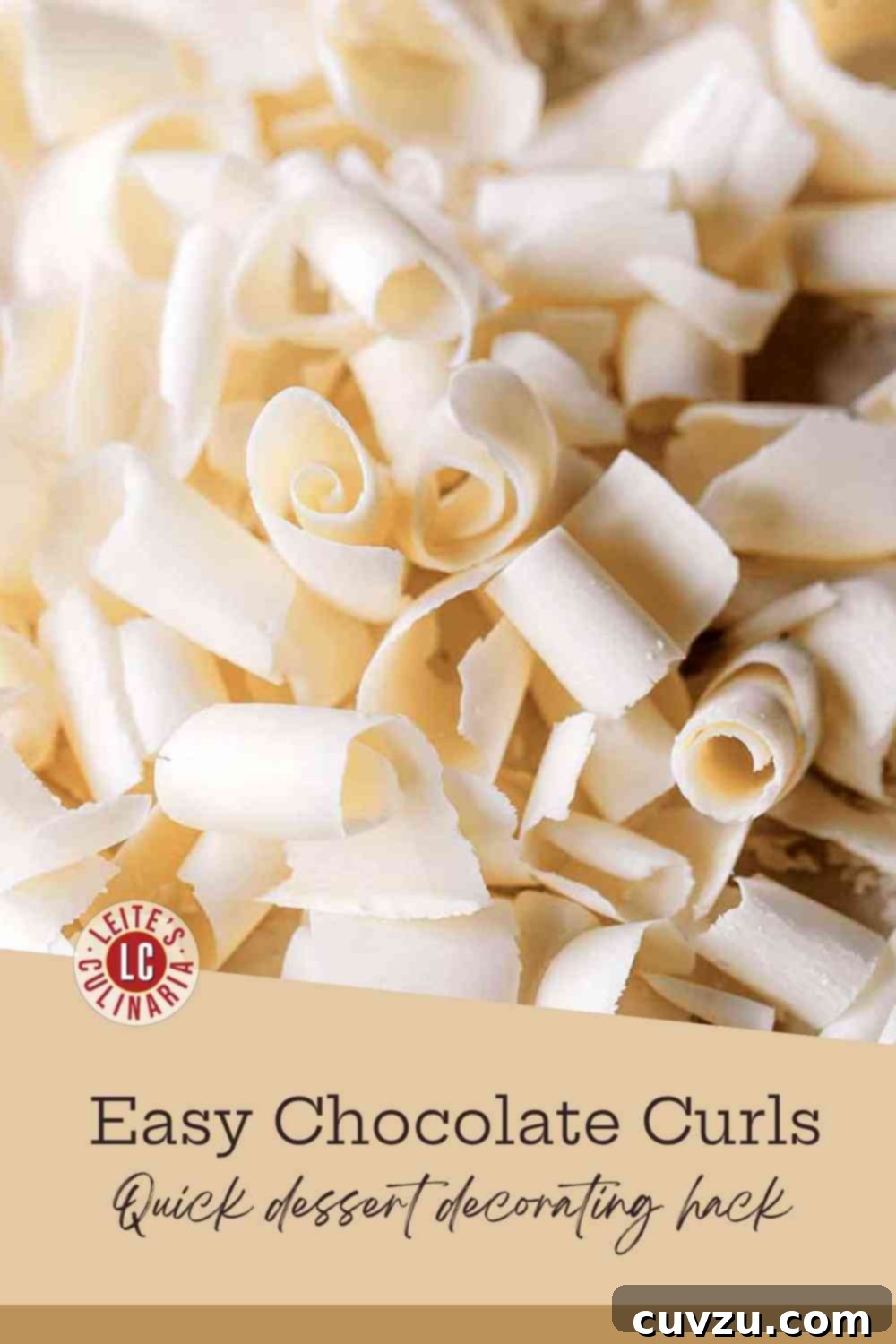 Your Guide to Perfect Chocolate Curls 3 Close-up of delicate white chocolate curls and shavings piled on a dark brown wooden board, highlighting their texture and beauty.