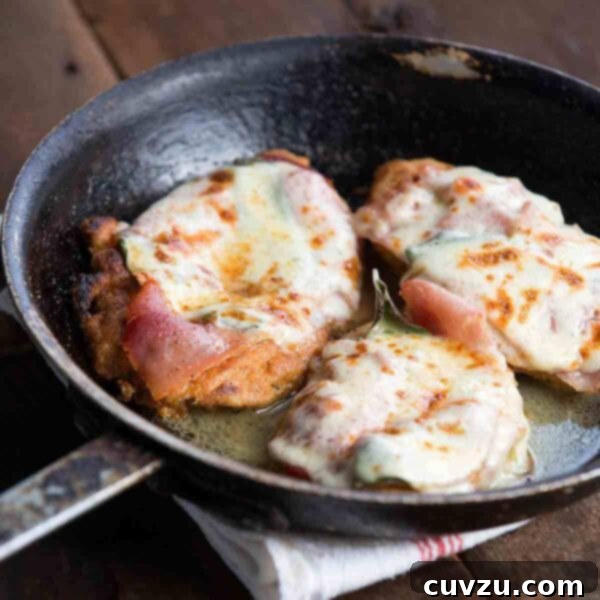 Prosciutto & Sage Chicken Saltimbocca 5 Three chicken cutlets wrapped in prosciutto and covered in cheese in a skillet.