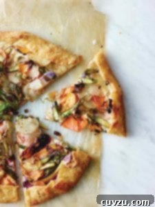 A round vegetable galette, with one slice cut out of it.