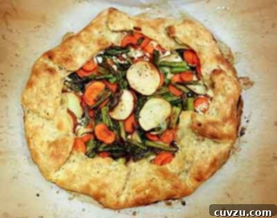 Savory Garden Galette 5 Colorful Vegetable Galette baked and on parchment paper cooling.