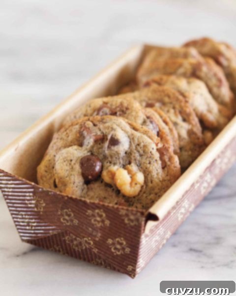 Several espresso chocolate chunk cookies in a paper container.