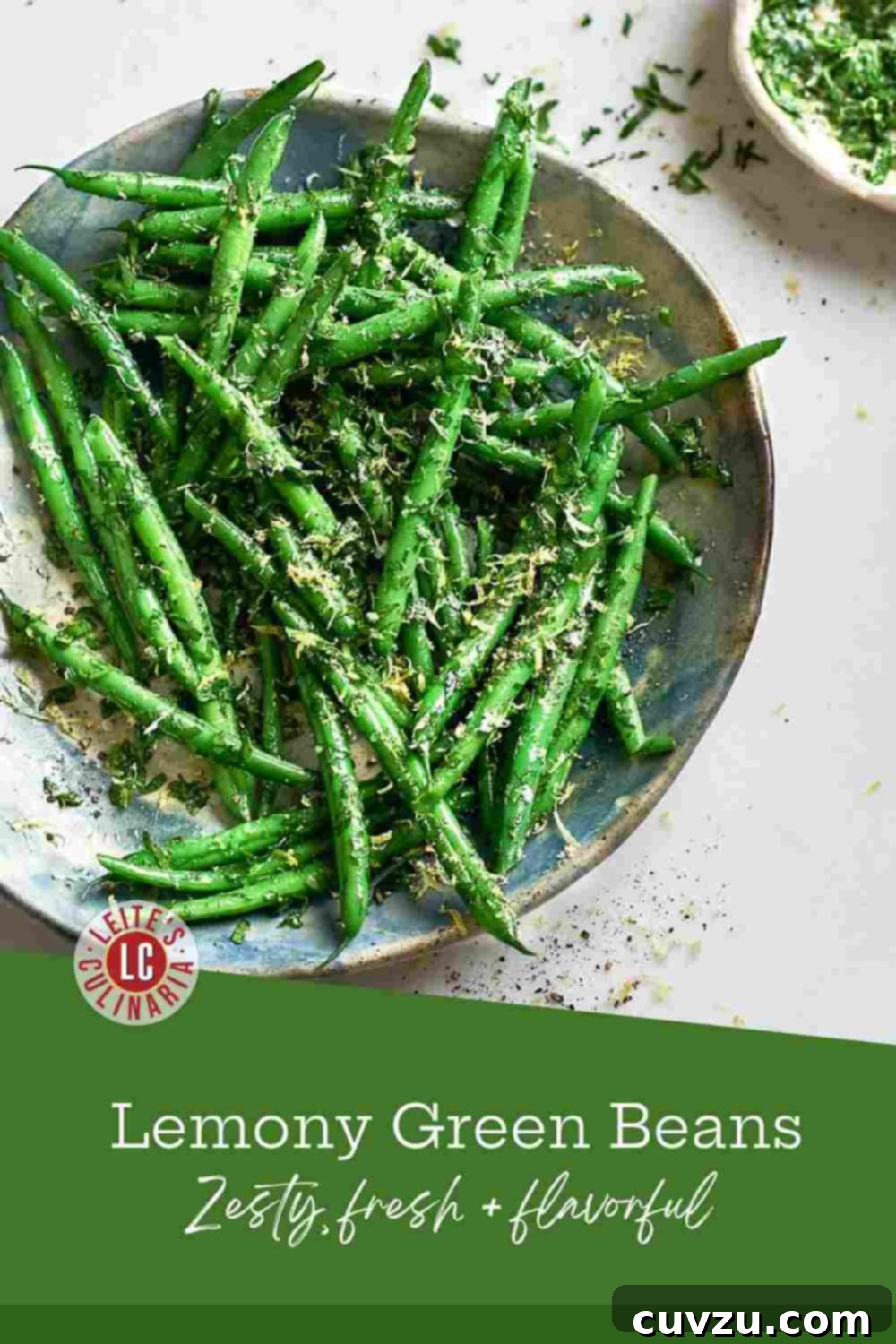 Bright Green Beans, Zesty Gremolata 3 Vibrant green beans, sprinkled with finely chopped parsley, and lemon zest served on a blue plate.