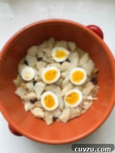 Portugal's Iconic Salt Cod Bake 7 A layer of neatly sliced hard-boiled eggs covering the salt cod in the Bacalhau à Gomes de Sá casserole.