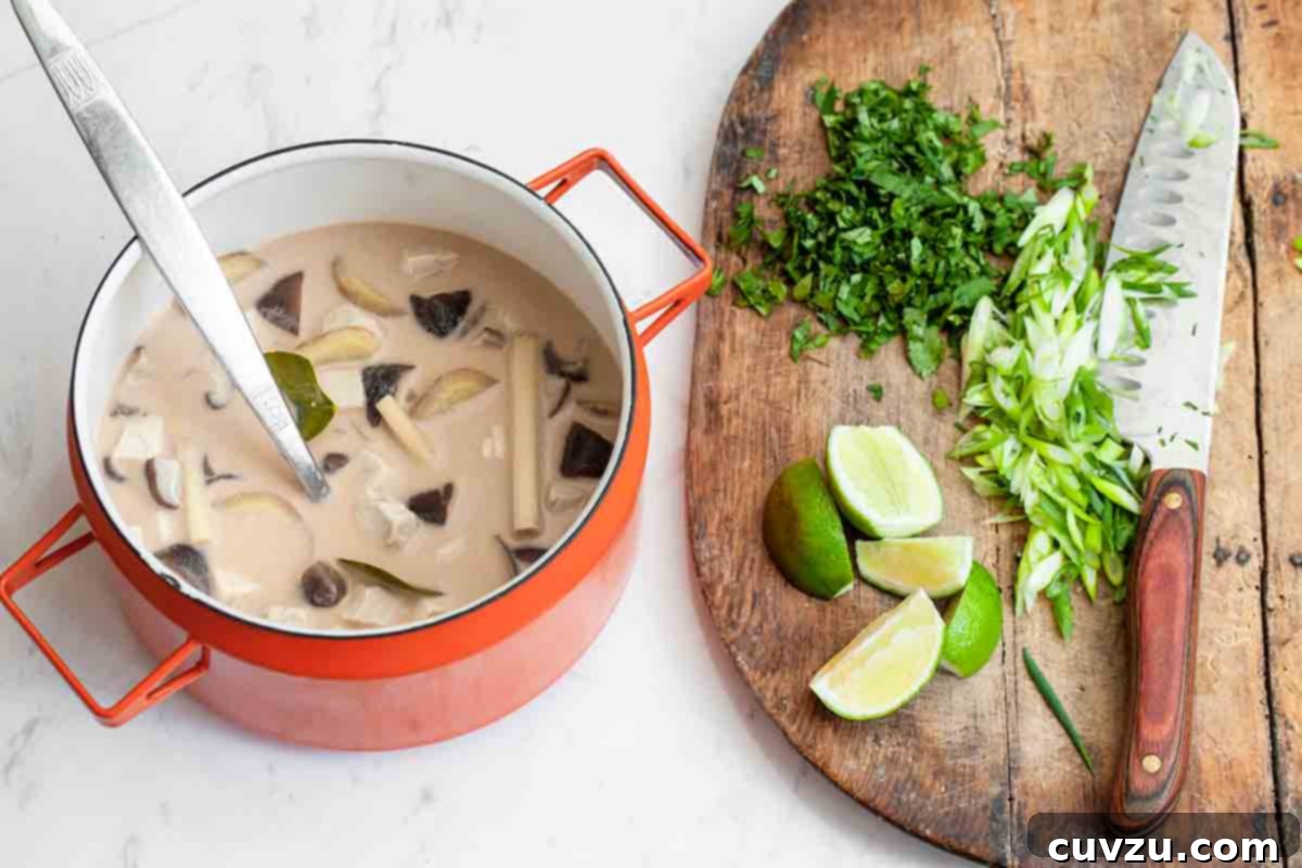 Vibrant Thai Lemongrass Coconut Chicken Soup 3 A close-up of Thai-inspired chicken soup with coconut milk and lemongrass, showcasing the colorful ingredients.