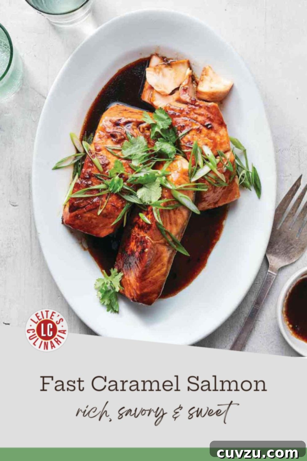 Perfectly glazed salmon fillets arranged on a pristine white platter, generously drizzled with a dark, glistening caramel sauce and adorned with a sprinkle of fresh cilantro and finely sliced scallions.