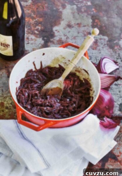 Caramelized Red Wine Onions 4 A red Le Creuset pot filled with red wine onions, that have been slowly cooked together.