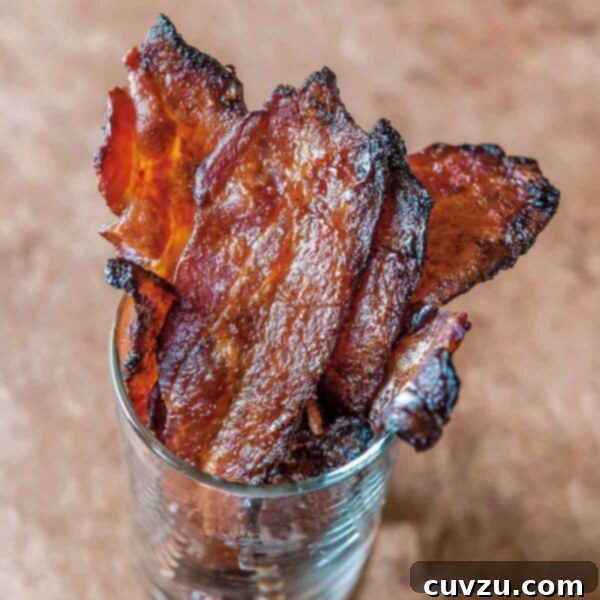 Several slices of maple sriracha bacon in a glass.