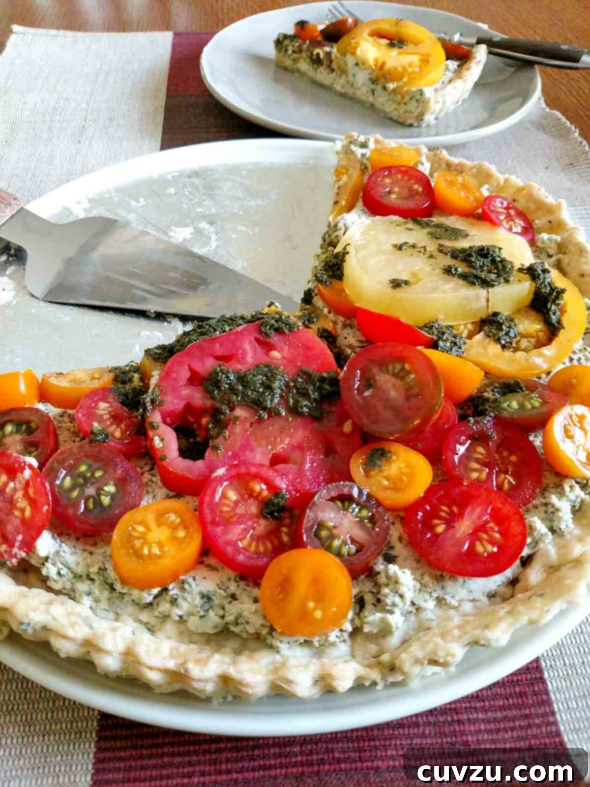 Savory Garden Tomato Galette 7 A fresh tomato tart in a herbed crust, beautifully drizzled with pesto vinaigrette, ready to be served.