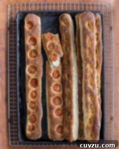 Jim Lahey's Mediterranean No-Knead Baguette 2 Five no-knead baguettes by Jim Lahey, some with sliced tomato, some with garlic and olives, beautifully golden and ready to eat.