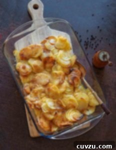 A glass casserole dish filled with golden brown easy scalloped potatoes
