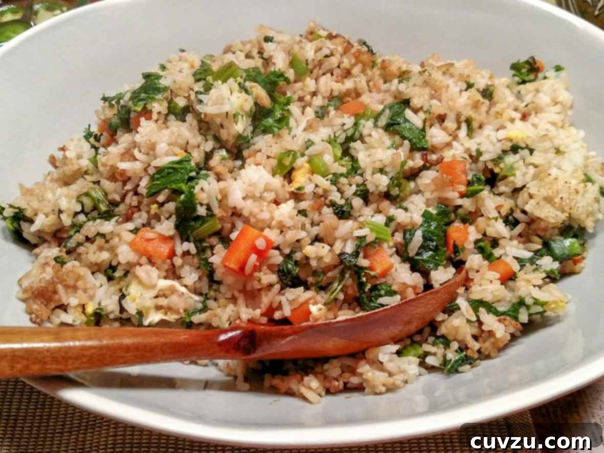 Kitchen Sink Fried Rice 5 A plate of fired rice with leftovers--rice, egg, carrots, peas