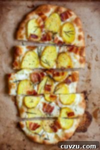 Farmhouse Potato Bacon Pizza 6 A sliced oval-shaped potato bacon pizza.