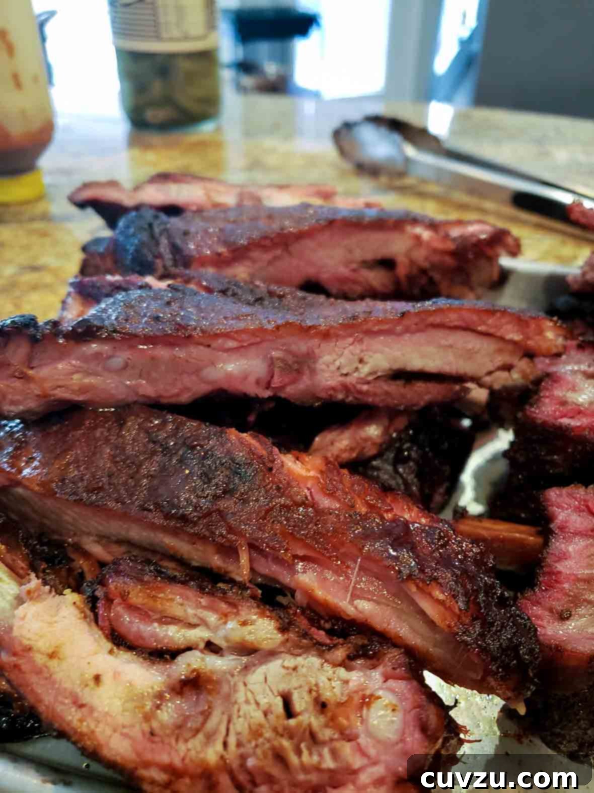 Fall-Off-The-Bone Smoked Pork Ribs 5 A beautiful pile of perfectly smoked pork ribs on a plate.
