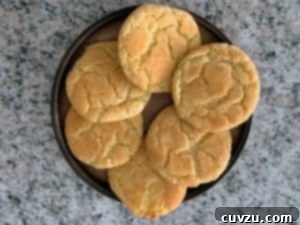Soft and Chewy Snickerdoodles 5 A brown plate topped with six perfectly baked snickerdoodles, arranged for serving.