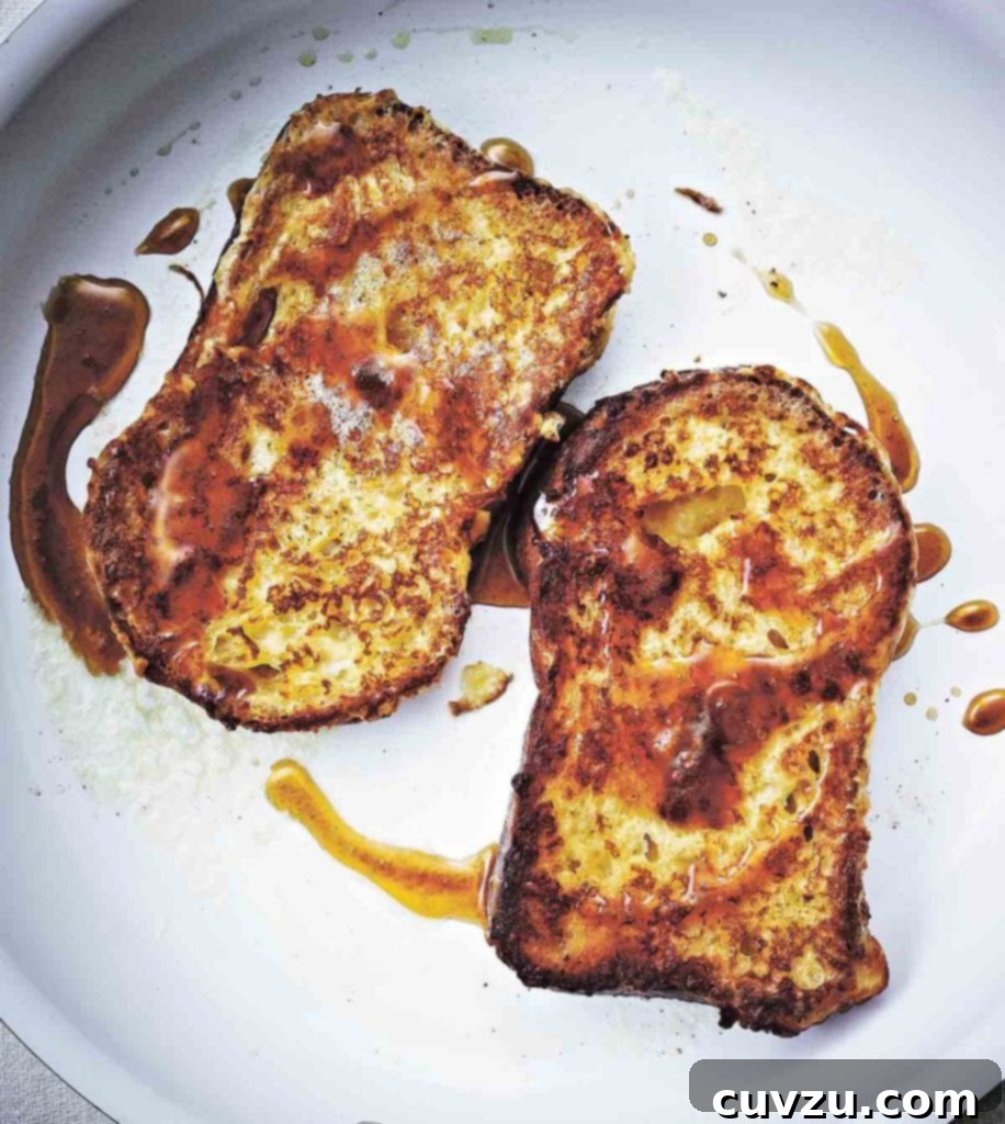 Golden Fluffy French Toast 2 Two slices of golden French toast, perfectly fried and drizzled with maple syrup.