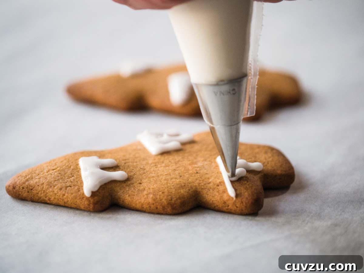 The Art of Royal Icing Decoration 2 Cookies being decorated with intricate royal icing designs for a festive occasion.