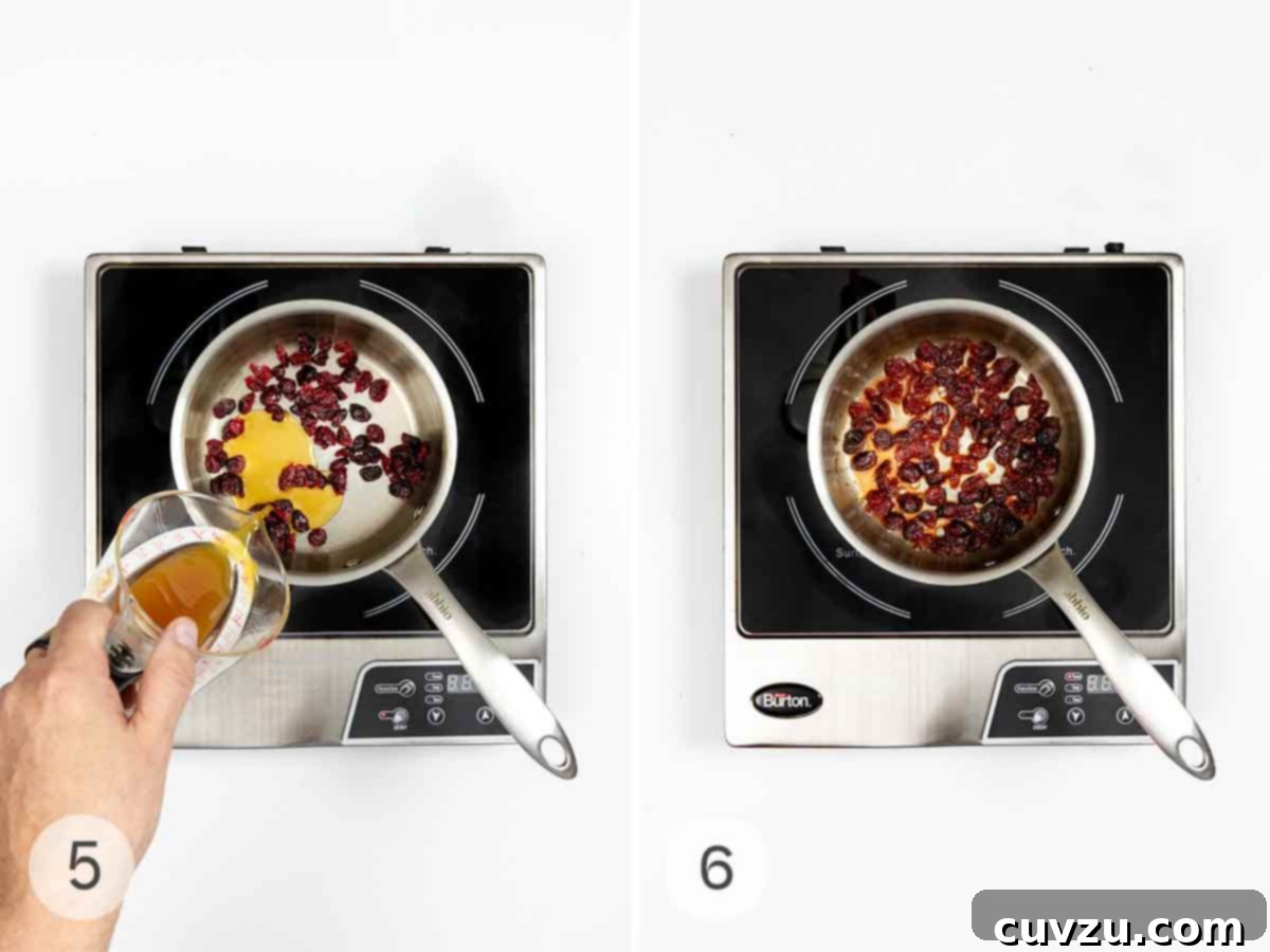 Kickin' Crispy Brussels 6 Apple juice being poured into a saucepan with dried cranberries, which then absorb the liquid and plump up.