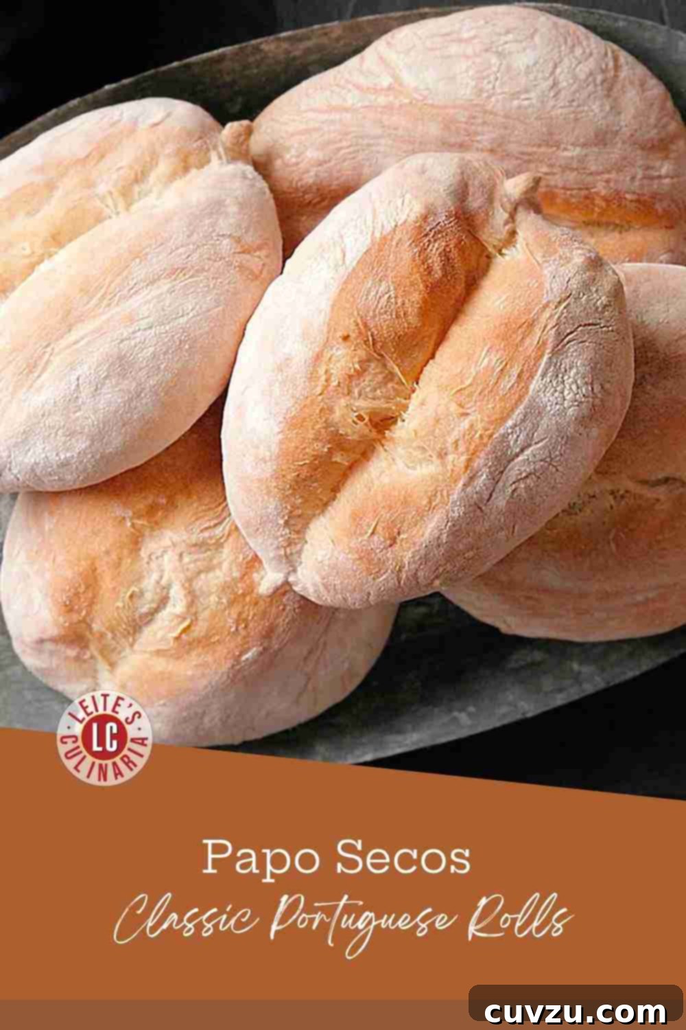 Papo Secos Portuguese Rolls 3 A charming tin platter showcasing a collection of warm, golden Portuguese rolls known as Papo Secos.