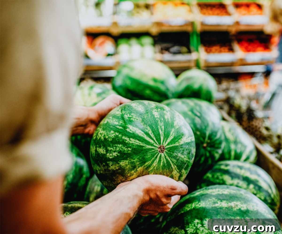 Picking the Perfect Watermelon 3 A person carefully selecting a watermelon from a large display, demonstrating the 'pick it up' technique.