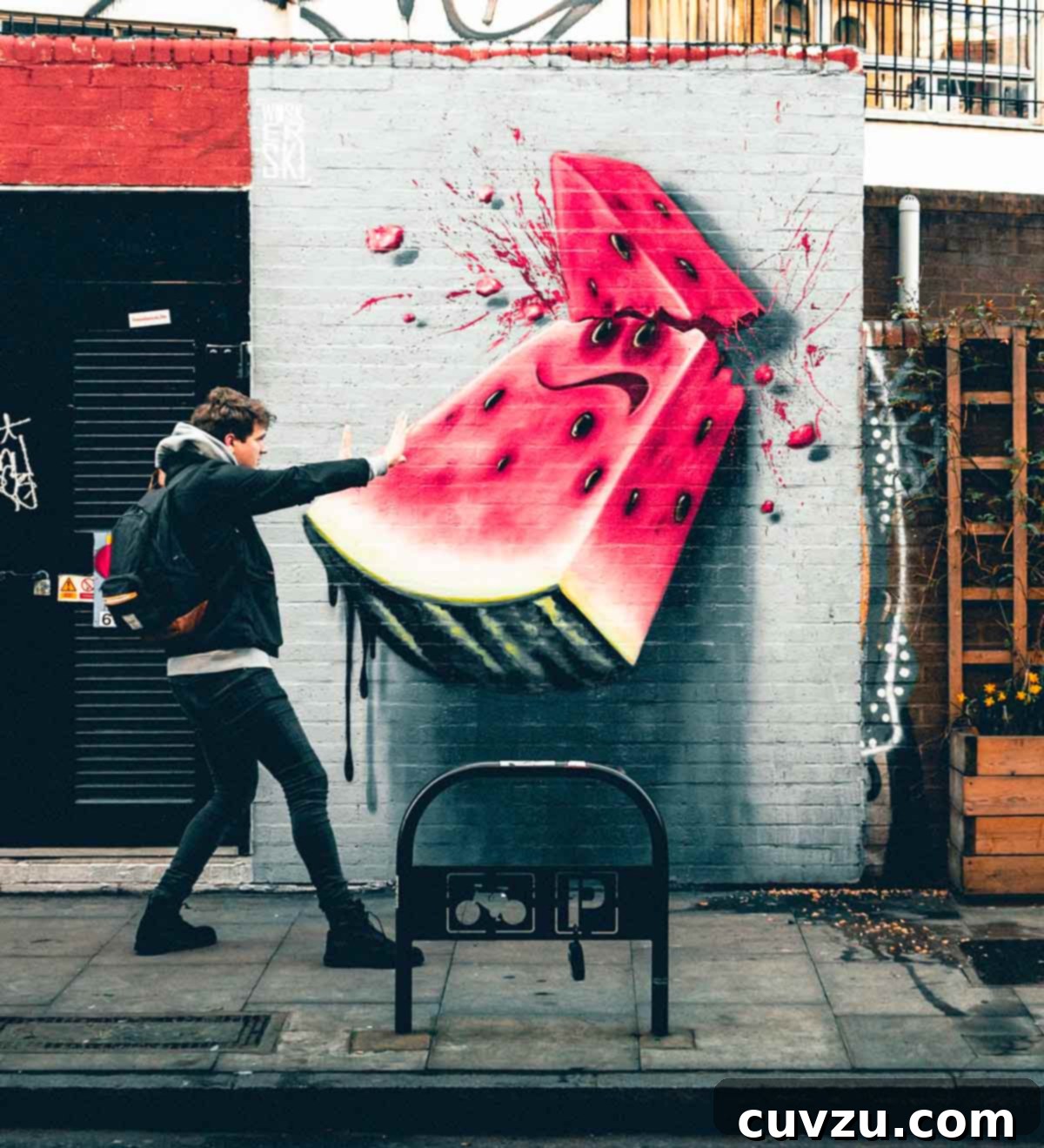 Picking the Perfect Watermelon 9 A person strikes a confident pose in front of a colorful watermelon graffiti wall, symbolizing their newfound mastery of watermelon selection.