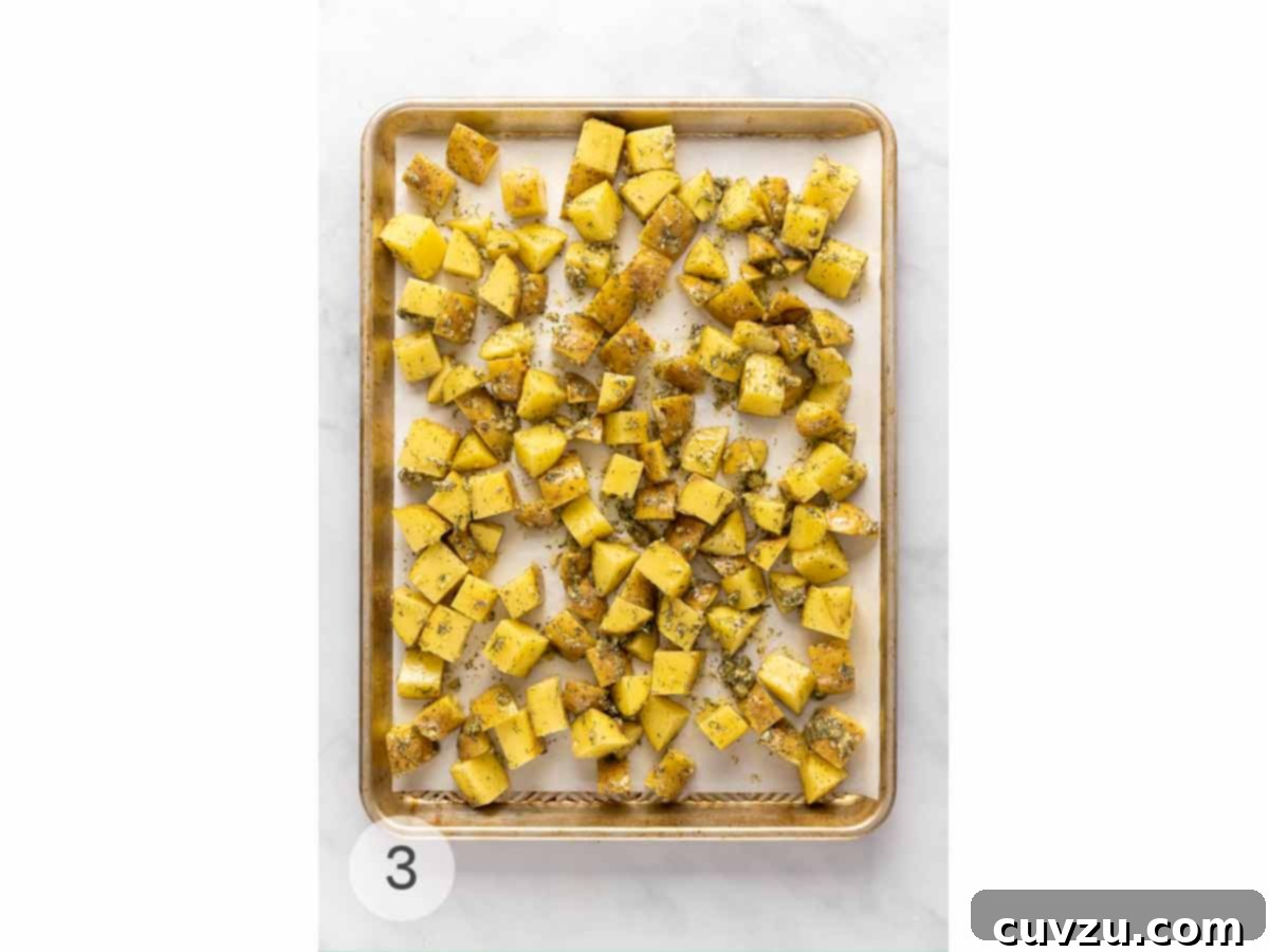 Golden Dill Roasted Potatoes 6 Cubed potatoes spread out on a baking sheet.