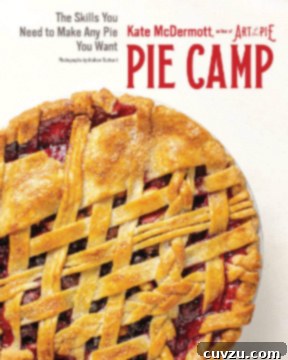 The cover of the Pie Camp Cookbook, featuring a rustic, homemade pie on a wooden surface.