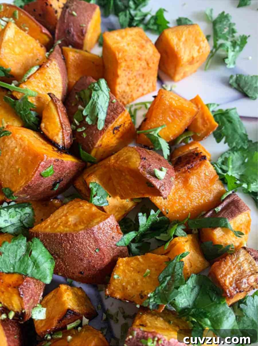 Vibrant Sriracha Lime Roasted Sweet Potatoes 6 Chunks of roasted sweet potatoes with Sriracha and lime wedges and sprigs of cilantro scattered over the top, prepared by Anne Anthony.