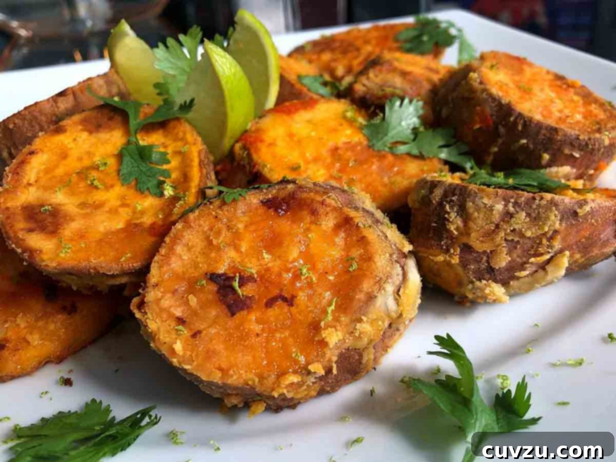 Vibrant Sriracha Lime Roasted Sweet Potatoes 7 Chunks of roasted sweet potatoes with Sriracha and lime wedges and sprigs of cilantro scattered over the top, a beautiful presentation by Ilda Costa-Sarnicki.