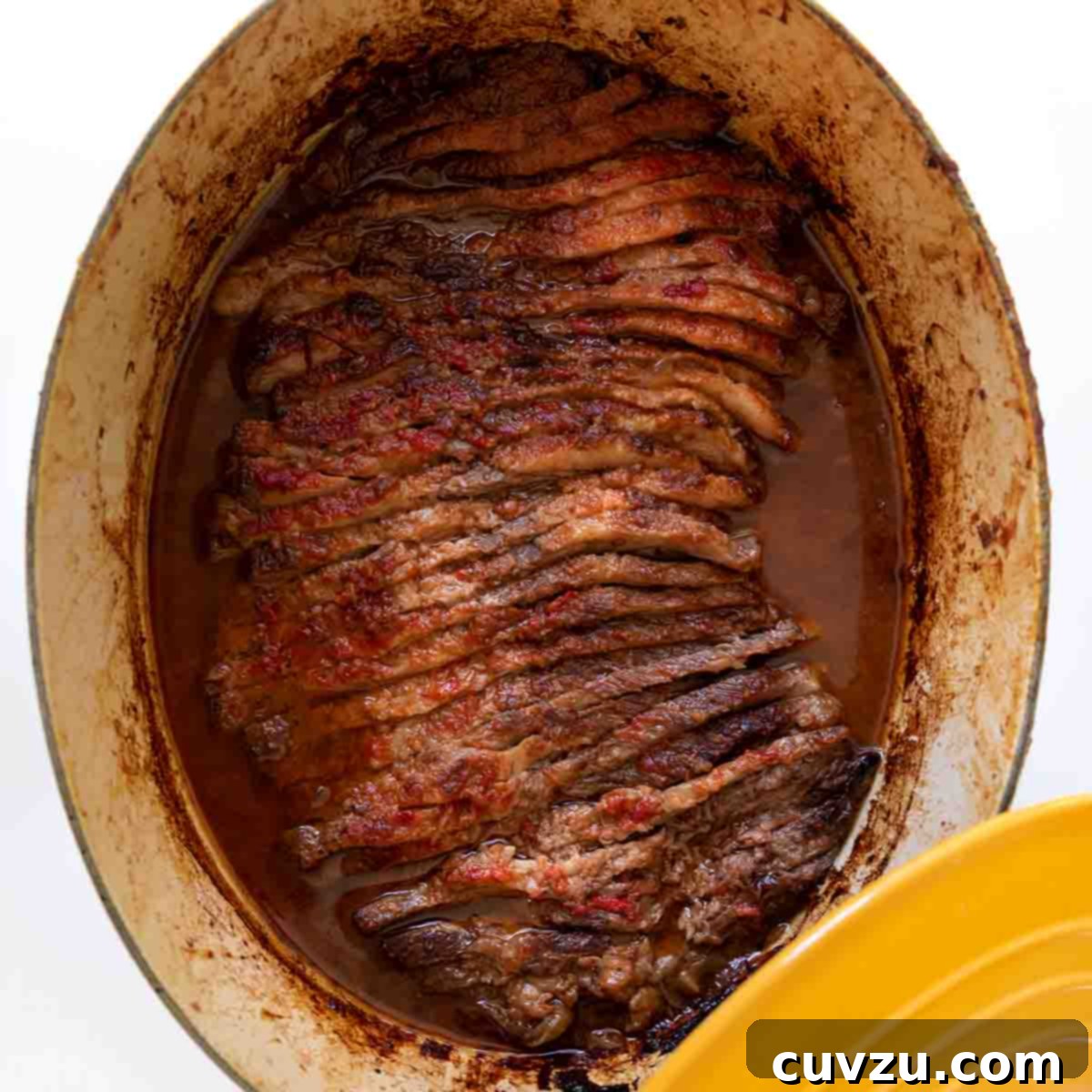 Light Up Your Table: 11 Hanukkah Recipes 3 A yellow Le Creuset pot with Nach Waxman's sliced beef brisket inside.