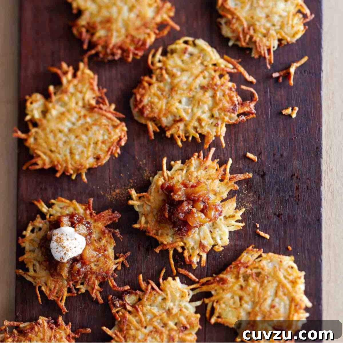 Light Up Your Table: 11 Hanukkah Recipes 7 Nine potato latkes with apple-date chutney and cinnamon sour cream on a wooden cutting board.