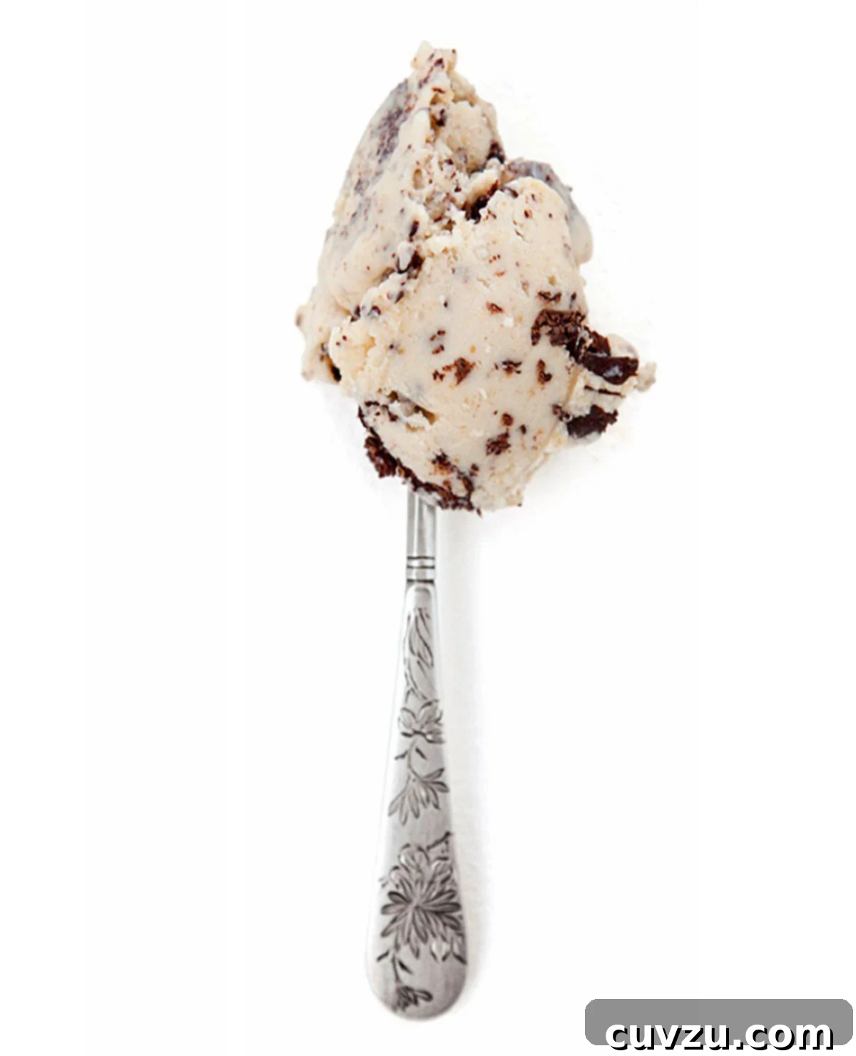 Salty Peanut Butter Chocolate Bliss 2 A scoop of rich, salted peanut butter ice cream with crunchy chocolate flecks resting invitingly on a gleaming silver spoon, promising a delightful dessert experience.