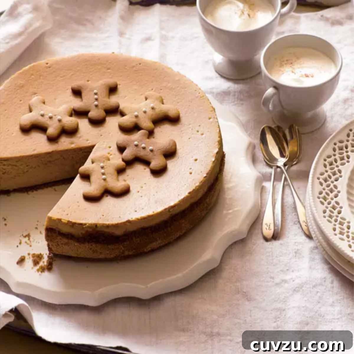 A whole gingerbread cheesecake on a white platter with a slice missing from it.