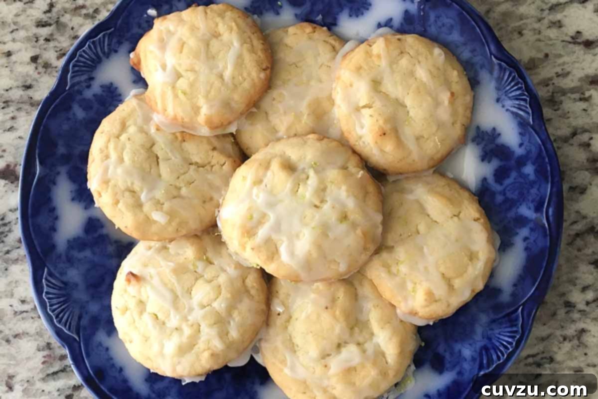 Lime Kissed Coconut Delights 7 Coconut lime cookies beautifully arranged on a blue ceramic plate.