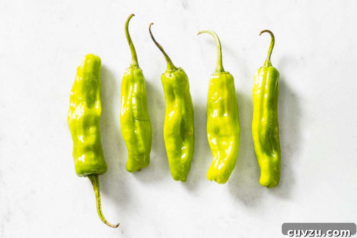 Fresh Chile Peppers: Decoding the Differences 5 A cluster of elongated, yellow-green Anaheim peppers, showcasing a mild to medium heat profile popular in Southwestern cuisine.