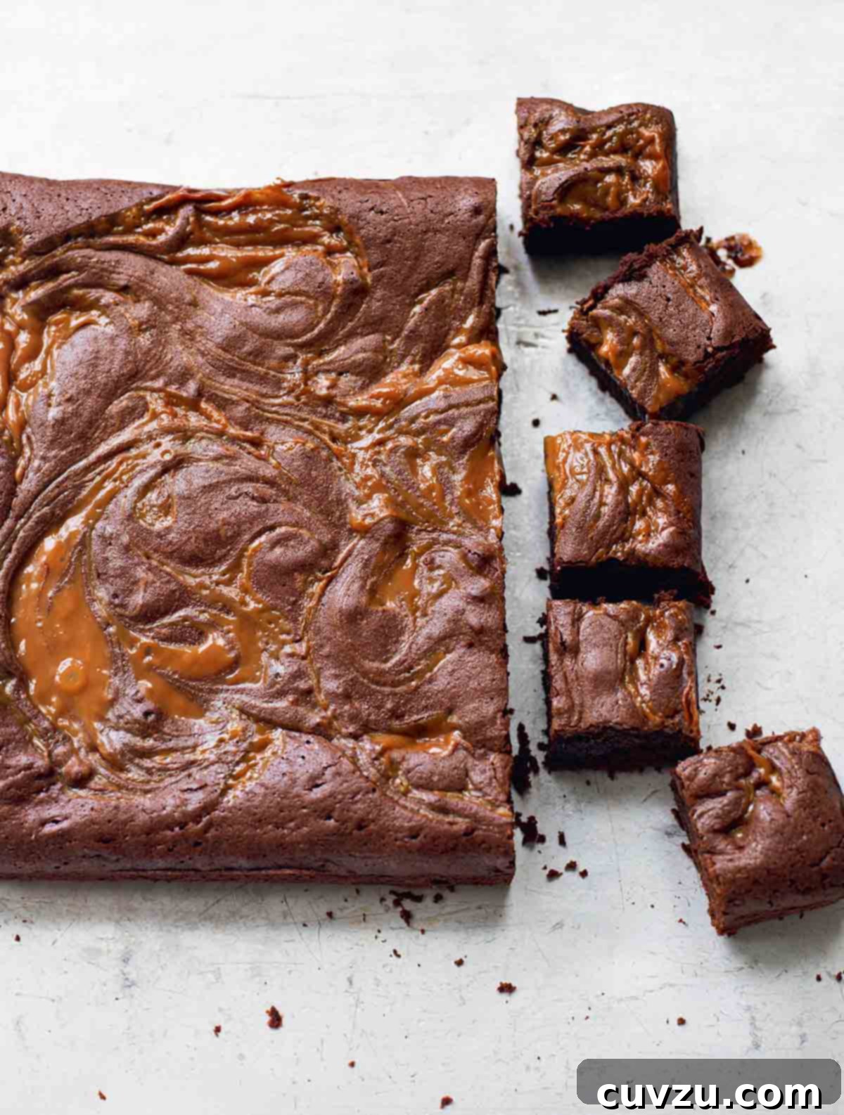 A slab of dulce de leche brownies, with five brownies cut from the end.