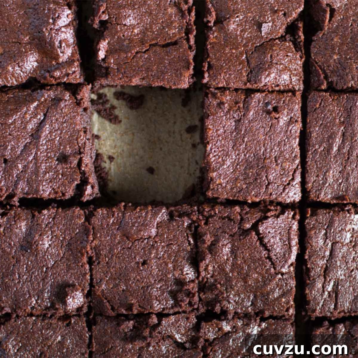 A tray of brownies for a crowd with one brownie missing.
