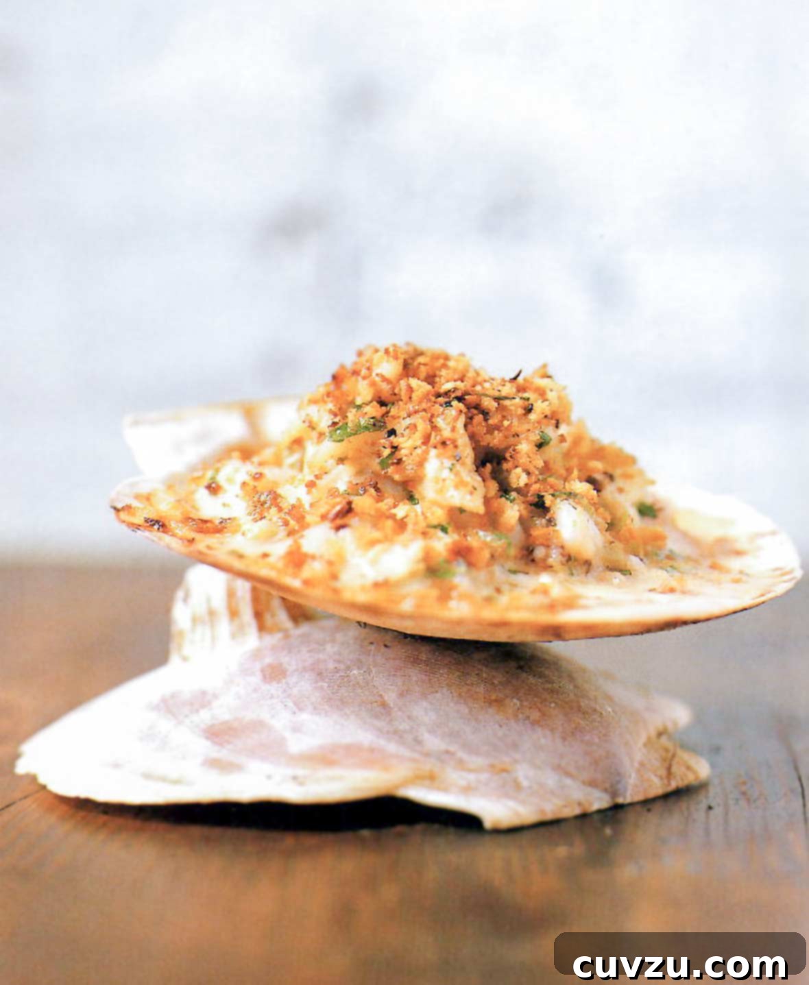 Baked seafood imperial—crab, shrimp, scallops, and calamari in a cream sauce, topped with bread crumbs and served on a water cracker.