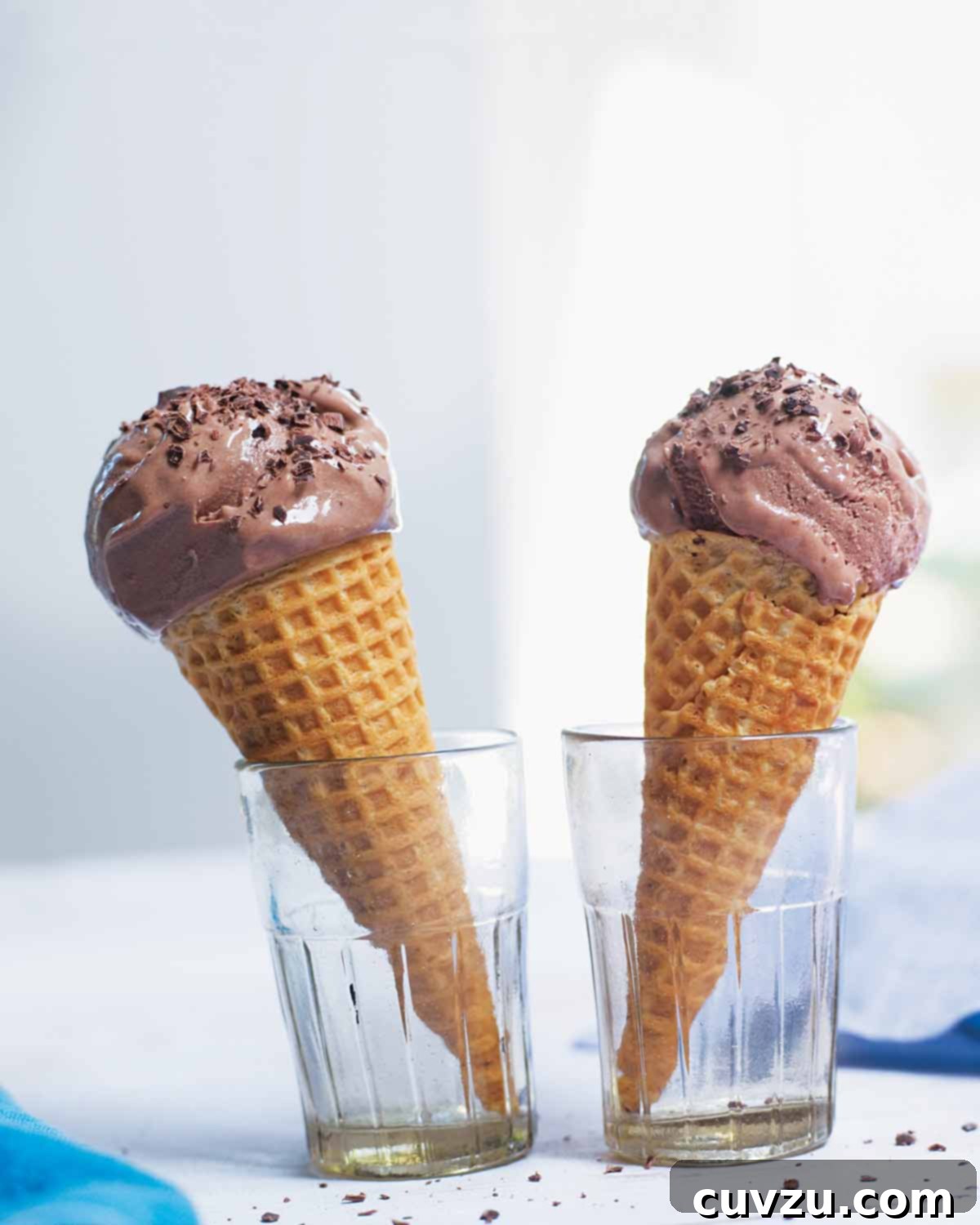 Two bitter chocolate and buttermilk ice cream cones in glasses, evoking childhood memories.