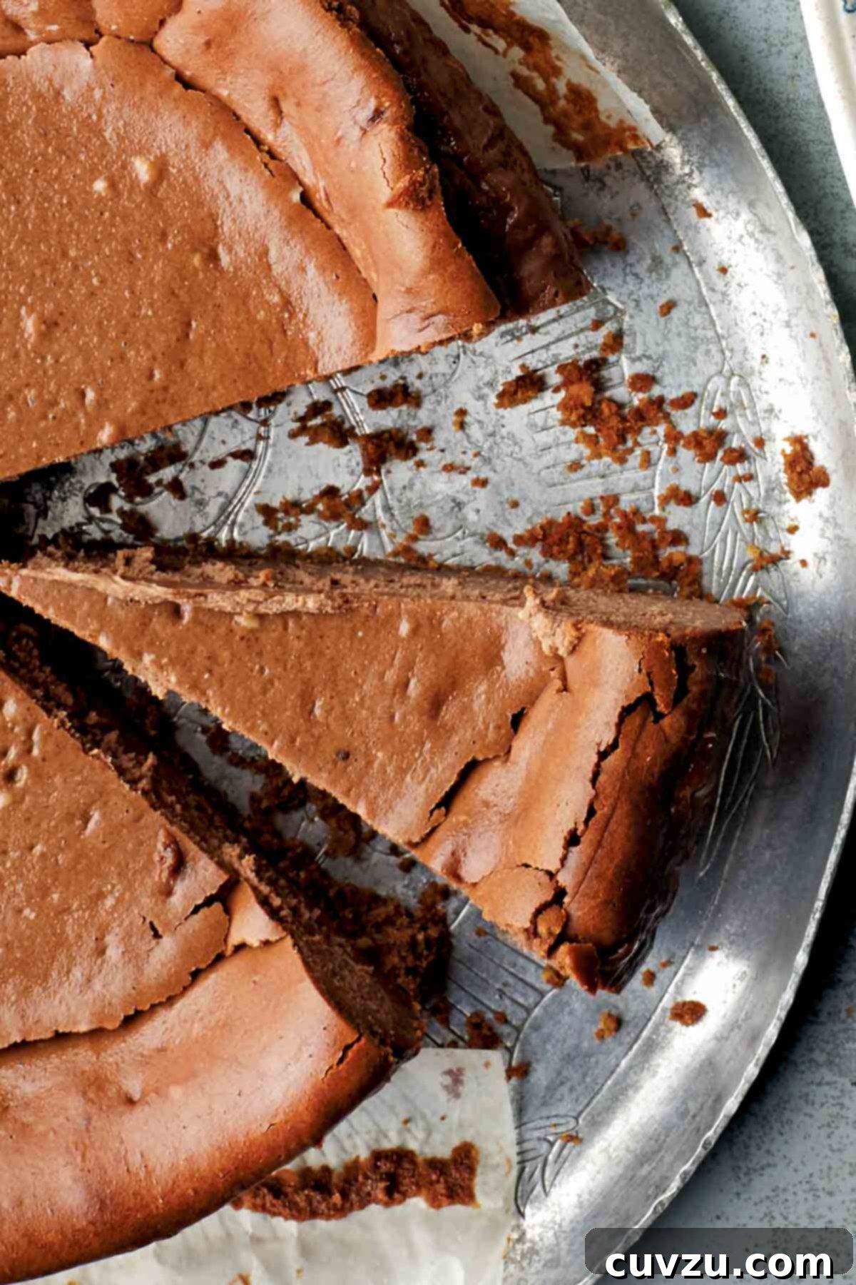 An espresso cheesecake on a silver platter with two slices cut from it, offering a decisive and rich treat for Gemini.
