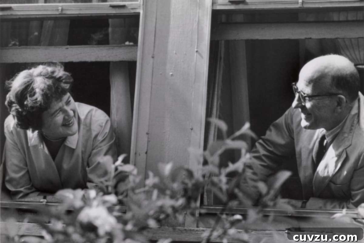 Julia Child Cooks Up a Series for HBO Max 4 Julia Child and Paul Child looking at each other out a window.