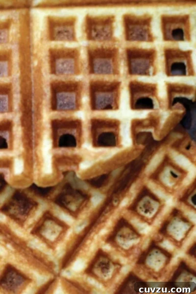 A close view of cornmeal waffles overlapping each other.