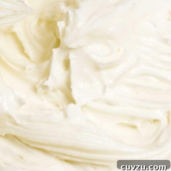 Decadent Homemade Cream Cheese Frosting 3 A close view of swirled cream cheese frosting, ready for use.