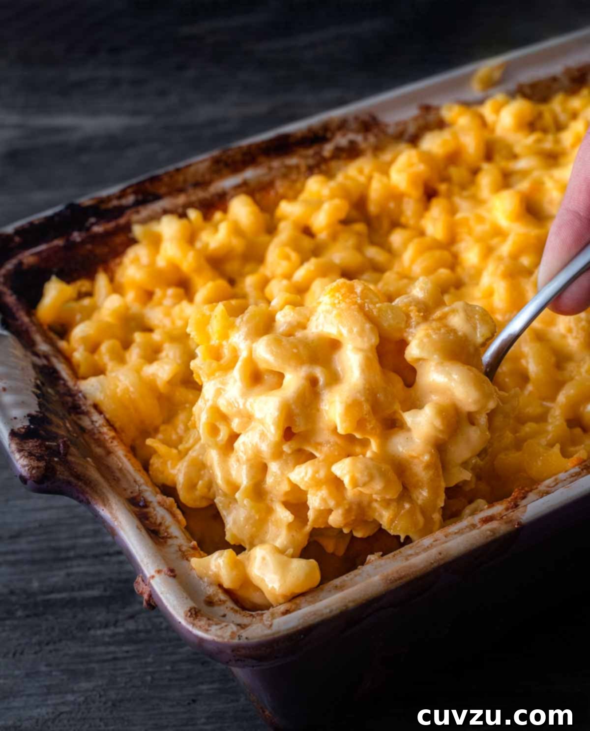 Elevate Your BBQ: 14 Must-Try Smoker Recipes 9 A large tray tray of cheesy elbow noodles and a spoon.
